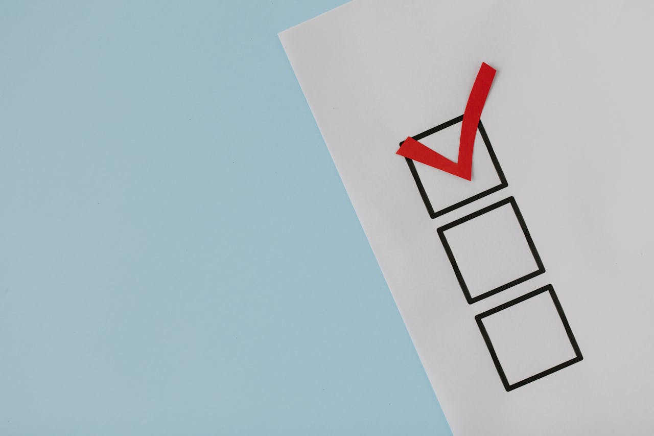about-02 A simple white paper checklist with one red checkmark, ideal for concepts like completion or approval.